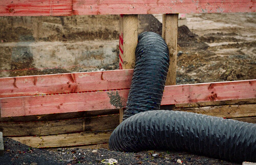 A length of flexible ducting pulled loose in a roof space