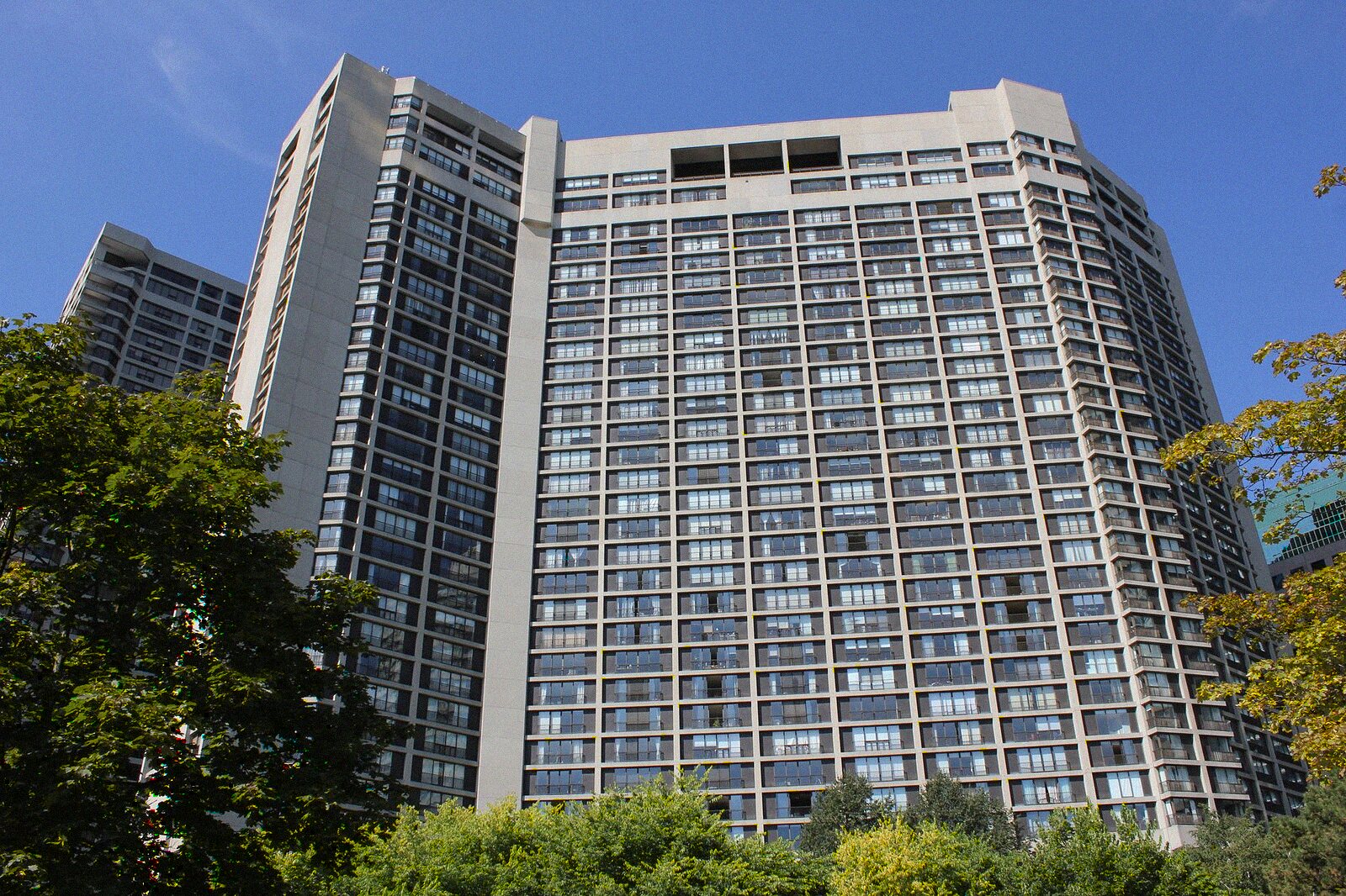 A tall residential condominium tower seen from street level